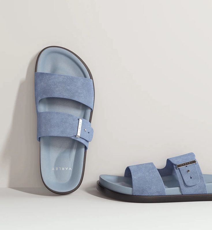 Blue sandals with a strap on a light gray background