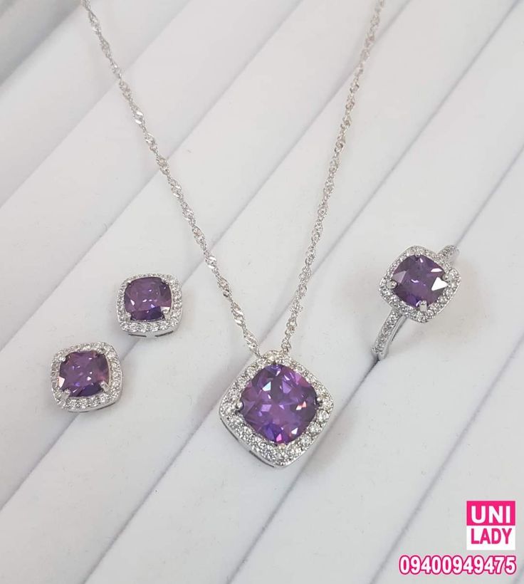 Jewelry set with purple gemstones on a white background