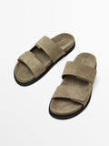 Pair of brown sandals on a white background