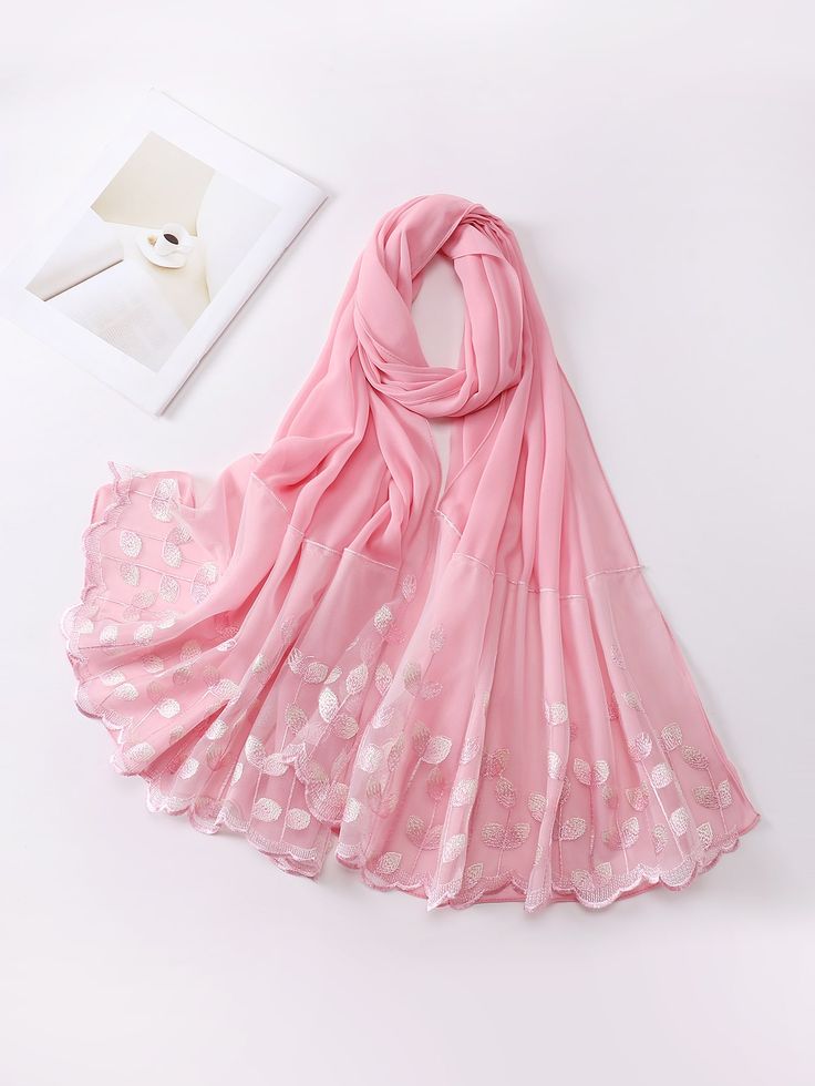 Pink scarf with floral patterns on a white background